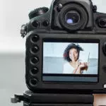 close-up of camera with woman in preview screen
